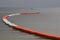 Line of floating orange and white buoys for marking safety zone