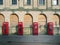 Line of four traditional british red phone boxes outside an old abandoned post office building in blackpool england