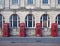 Line of four traditional british red phone boxes outside an old post office building in blackpool england