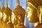 A line of golden statues of the Buddha