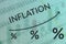 Line graph growth inflation process on blue and green background of columns of numbers and candle graph. Soft focus background