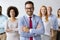 Line of happy and positive business people standing in the office