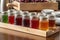line of homemade jams and jellies in glass jars on wooden rack