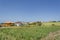 Line Of Houses On Landscape Below Blue Sky