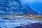 Line of Lonely Houses in Norwegian Snowy Mountains at Skagsanden Beach Duding Spring Time.