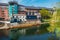 Line of moored rowing boats on the banks of River Wear near a boat club in Durham, United Kingdom on a beautiful spring afternoon