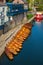 Line of moored rowing boats on the banks of River Wear near a boat club in Durham, United Kingdom on a beautiful spring afternoon