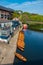Line of moored rowing boats on the banks of River Wear near a boat club in Durham, United Kingdom on a beautiful spring afternoon