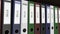 Line of multicolor office binders with Bills tags. 4K seamless loop clip