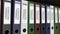 Line of multicolor office binders with Criminal records tags. 4K seamless loop clip