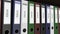 Line of multicolor office binders with Ideas tags. 4K seamless loop clip