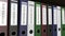 Line of multicolor office binders with Invoices tags different years 3D rendering