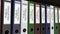 Line of multicolor office binders with Public relations tags. 4K seamless loop clip