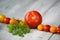 Line of natural organic red and yellow cherry tomatoes, tomato and fresh herbs on wooden background