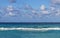 Line of the ocean, small waves, horizon, endless distance, against the sky covered with clouds