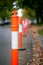 A line of orange and white traffic bollards with shallow depth of field