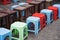 Line of plastic chairs with blur wooden table on Asian street. Concept of drinking tea, coffee and having fast food outdoor