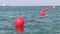 A line of red buoy floating in the sea waves for safety purpose