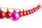 Line of red christmas balls and one lilac or purple ball on white background. Christmas decorations.