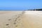 A line of seaweed and shells shows the high tide mark on a beach in Jersey