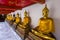 Line of sitting Buddhas at the Wat Pho temple, Bangkok, Thailand