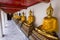Line of sitting Buddhas at the Wat Pho temple, Bangkok, Thailand
