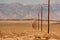 Line of telegraph poles across the desert