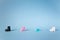 Line of toy shoes isolated on blue background with copy space. Concept of social distance. Keep a social distancing