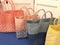 Line up of different colored beach bags