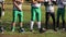 Line-up of professional football players listening to coach\'s instructions