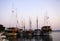 Lined tourist sailing ships full of happy tourists anchored in port in the evening blue hour