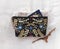 Linen Clutch Bag, ethnic style with floral embroidery on a gray canvas background, handmade steps