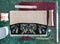 Linen Clutch Bag, ethnic style with floral embroidery on a gray canvas background, handmade steps