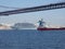A liner and a red freighter meet under the bridge of April 25 in Lisbon, Portugal, Europe