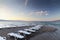 Lines of beach chairs on sand bank