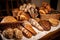 lineup of freshly baked breads, with different types and shapes for variety