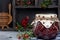 Lingonberry jam or sauce in a glass jar with cranberries, cowberries on wood background