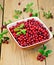 Lingonberry ripe in bowl on board