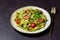 Linguini pasta with pesto sauce, tomatoes and cheese. Healthy eating. Vegetarian food. Italian cuisine