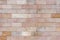 Lining on the wall with decorative brick from travertine of warm shades