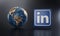 LinkedIn Logo Beside Earth 3D Rendering. Top Apps Concept