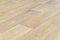 Linoleum flooring with embossed light wood texture close-up. Horizontal layout perspective.