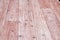 Linoleum flooring with nice embossed wood texture. Imitation wooden floor in pink color