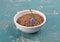 Linseed and common flax in bowl on weathered concrete