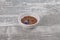 Linseed and common flax in bowl on weathered wood