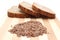 Linseed on cutting board and slices of wholemeal bread