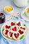 Linzer cookies with heart with raspberry jam and powdered sugar on a white plate with a cup of tea. Dessert on Valentine`s Day.