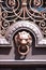 A Lion knocker on a stained door.