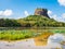 Lion rock in Sigiriya, Sri Lanka with reflections in swampy lake