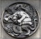 Lion and snake. Stone relief at the building of the Faculte de Medicine Paris.